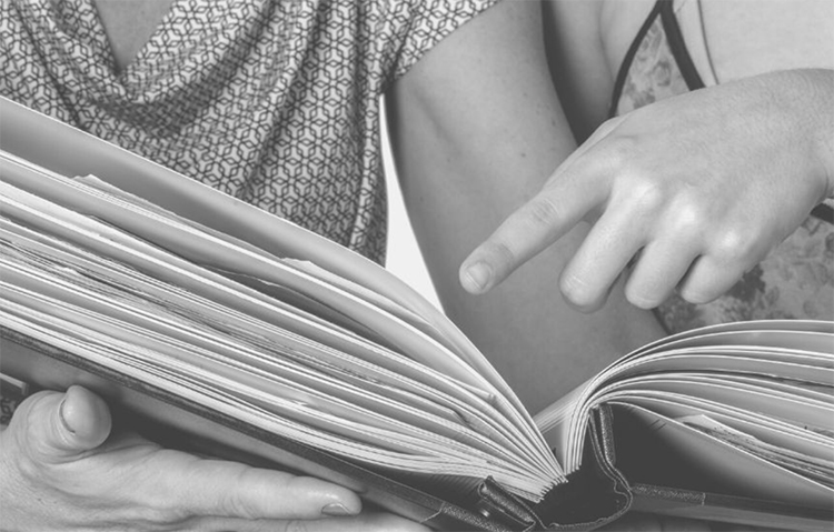 looking at albumn cropped Capture your story with our quality handmade albums and online co-creation sessions